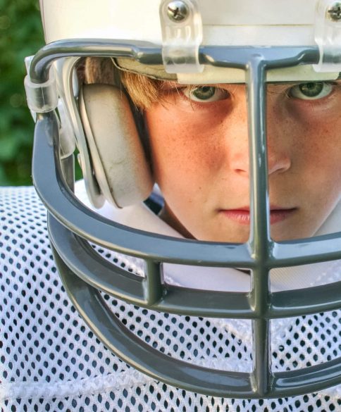 young boy in football uniform